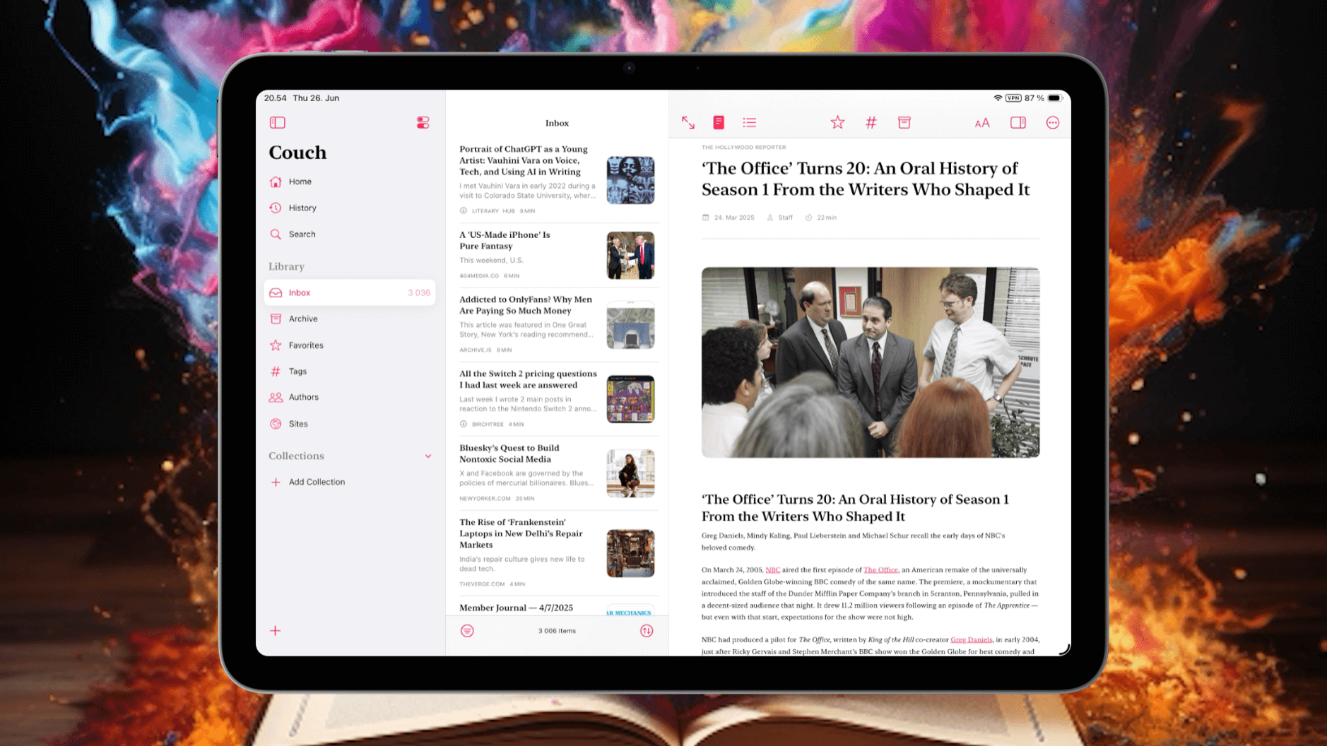 A digital tablet displaying an article titled "The Office Turns 20: An Oral History of Season 1 From the Writers Who Shaped It", with a photo of the cast in a room, and a list of articles including "Portrait of ChatGPT as a Young Artist: Vauhini Vara on Voice, Tech, and Using AI in Writing" and "Addicted to OnlyFans? Why Men Are Paying So Much Money". The tablet is set on a blurred background with artistic lighting.
