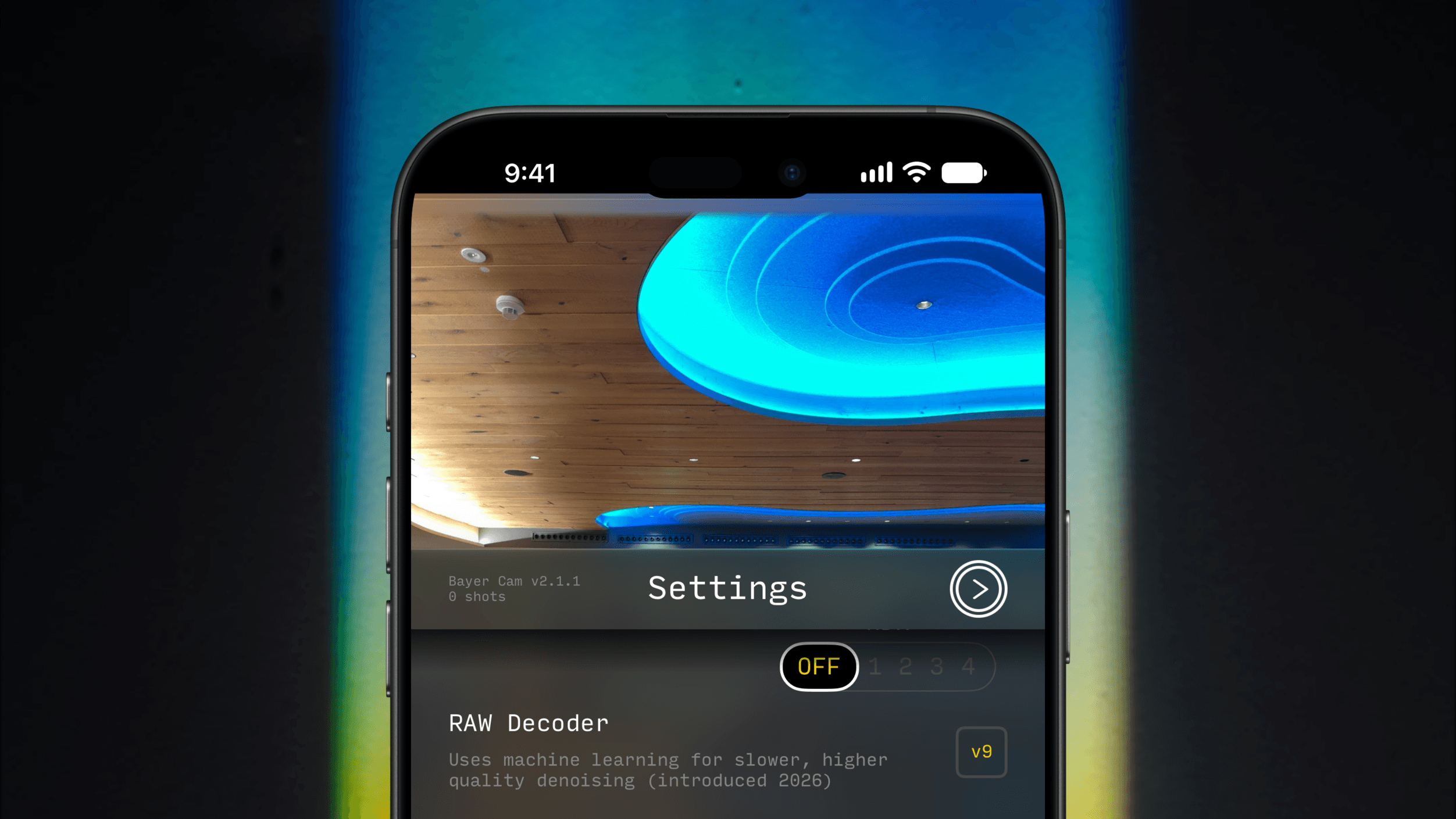 A close-up of a smartphone screen displaying a camera settings interface labeled 'Bayer Cam v2.1.1'. The screen shows a photo of a wooden ceiling with blue modern lighting and an option for RAW Decoder with machine learning denoising settings, currently switched off.