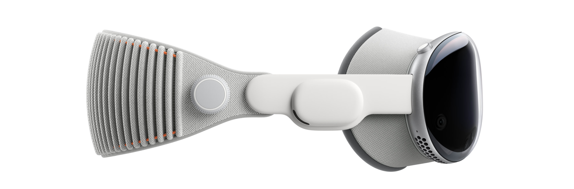 Das Bild zeigt Apple Vision Pro mit einem grauen, gewebten Kopfband, einem runden, silbernen Bedienelement an der Seite und einem schwarzen, glänzenden Display-Teil auf der rechten Seite, welches ein Bildschirm für virtuelle Realität ist.