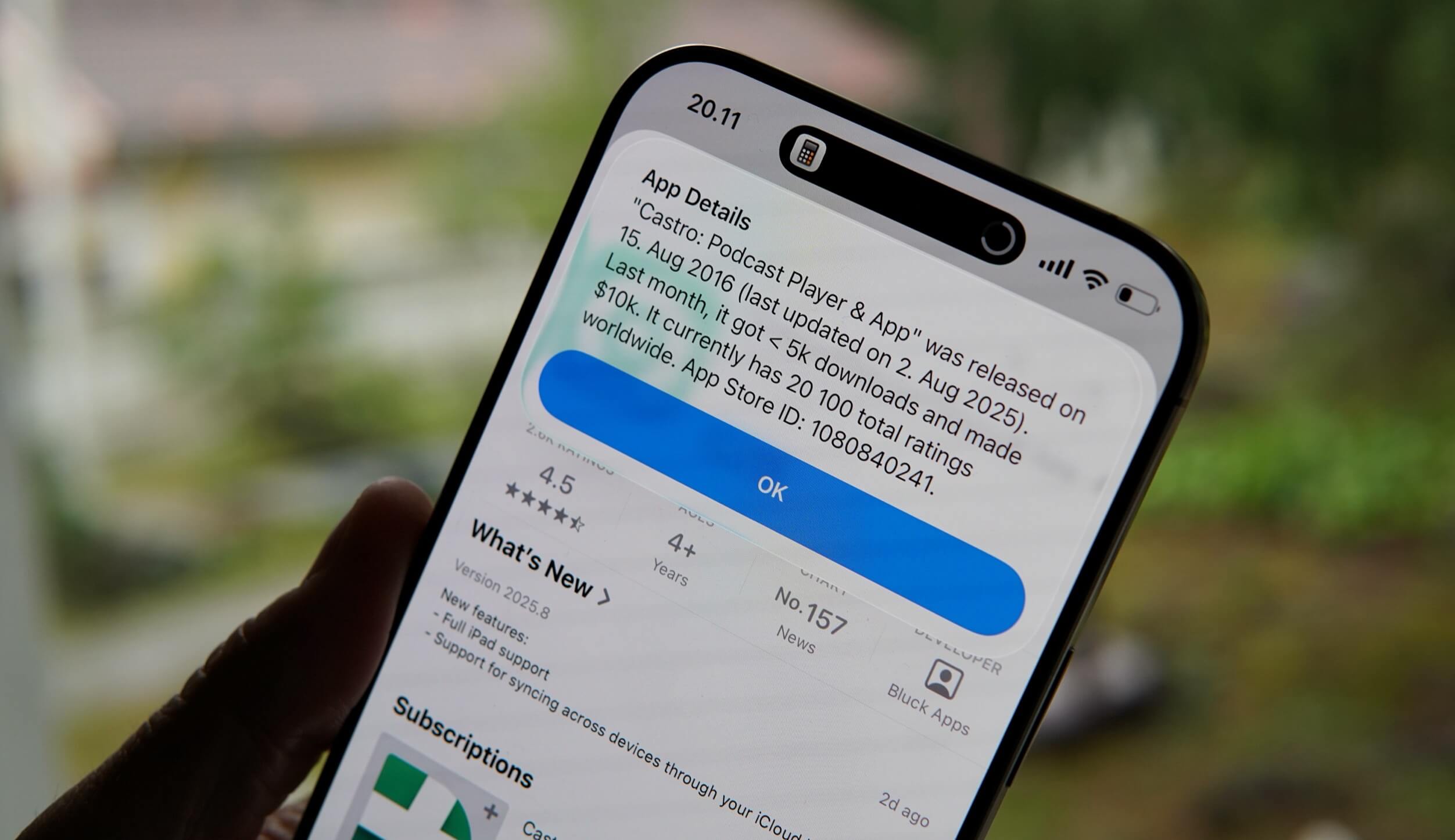 Close-up of an iPhone screen displaying the App Store details for the "Castro: Podcast Player & App", showing release and update dates, download and revenue statistics, user ratings, and a list of new features, with an "OK" button highlighted on the screen.
