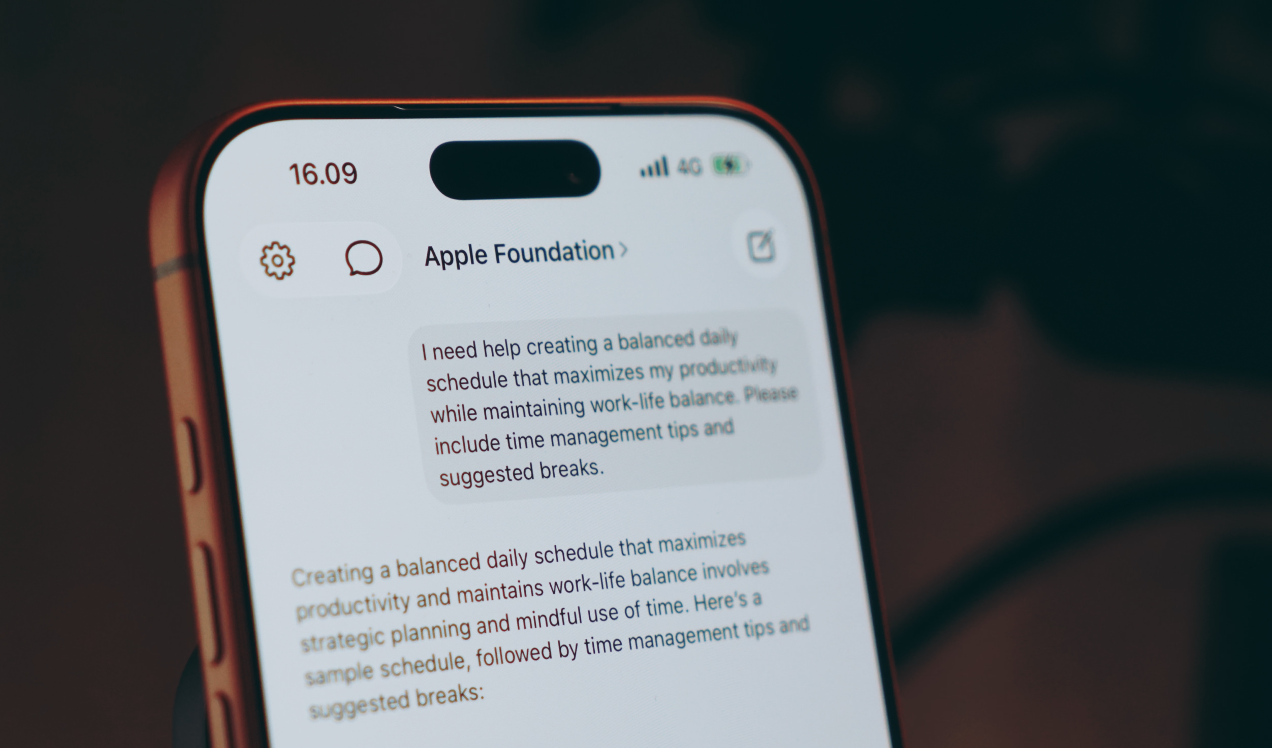 Close-up of a smartphone screen displaying a chat conversation with "Apple Foundation," asking for help creating a balanced daily schedule for work-life balance, with time management tips and suggested breaks.
