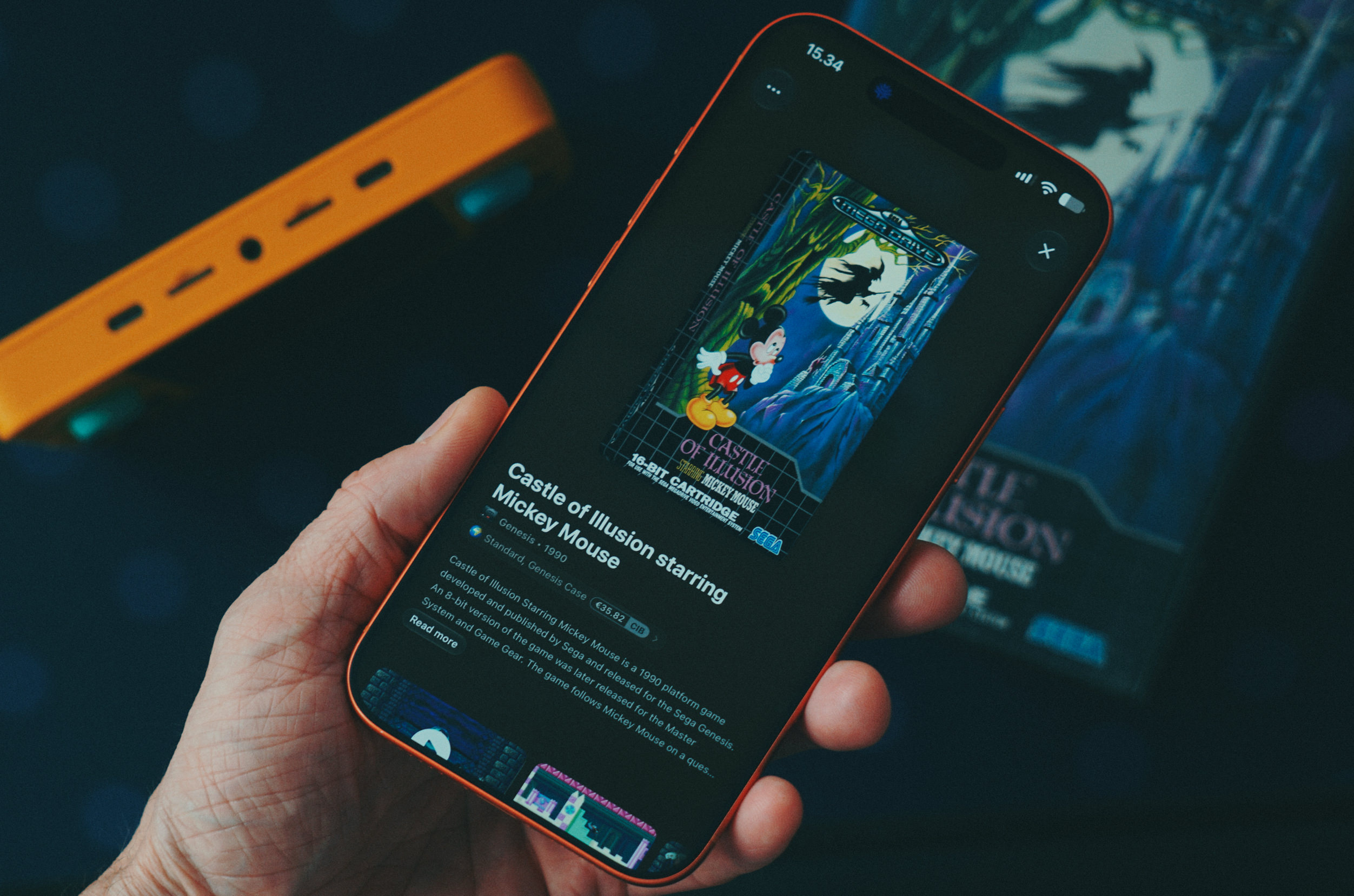 A smartphone screen displaying game information for the 1990 title Castle of Illusion starring Mickey Mouse.